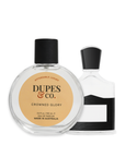Dupes & Co. perfume bottle with a smaller perfume bottle and tag on a wooden surface.