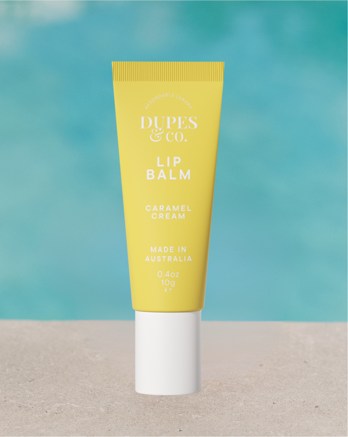 Dupes & Co Caramel Cream Lip Balm tube front view