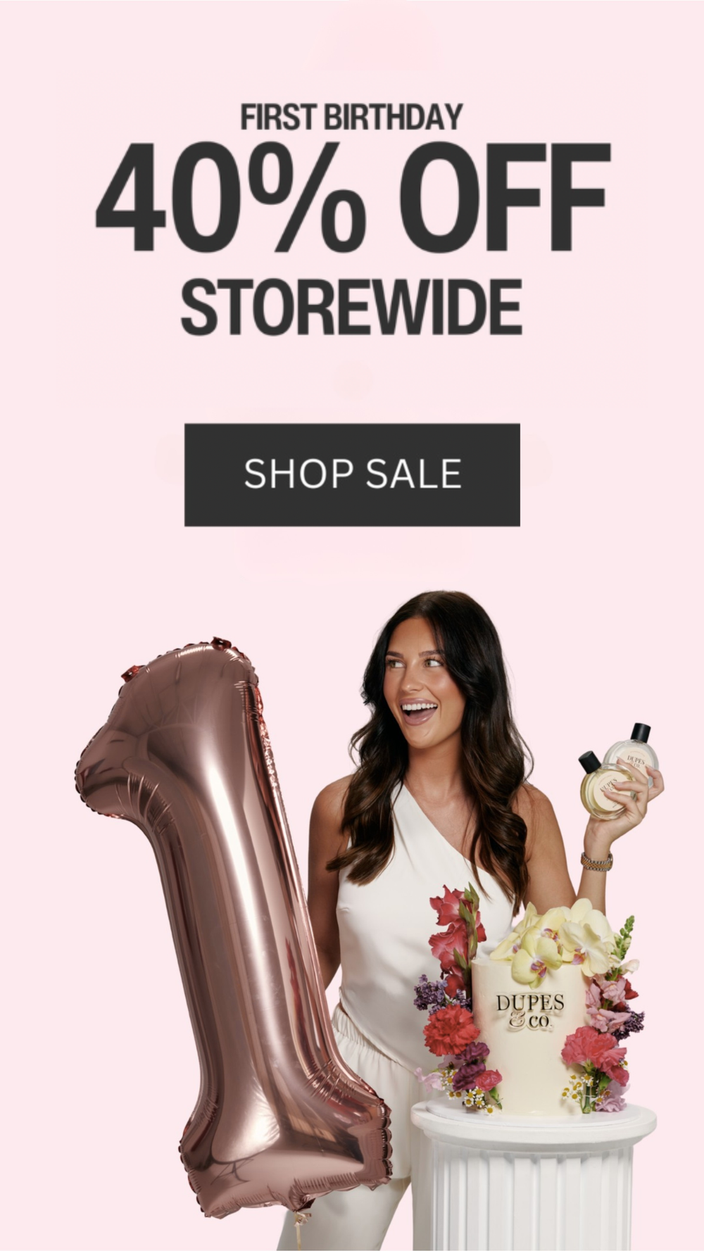 Woman holding a perfume bottle beside a rose gold number one balloon and a floral display, with text reading “Trusted by 25,000+ Fragrance Lovers – First Birthday 40% Off Storewide” and a Shop Sale button on a pink background.