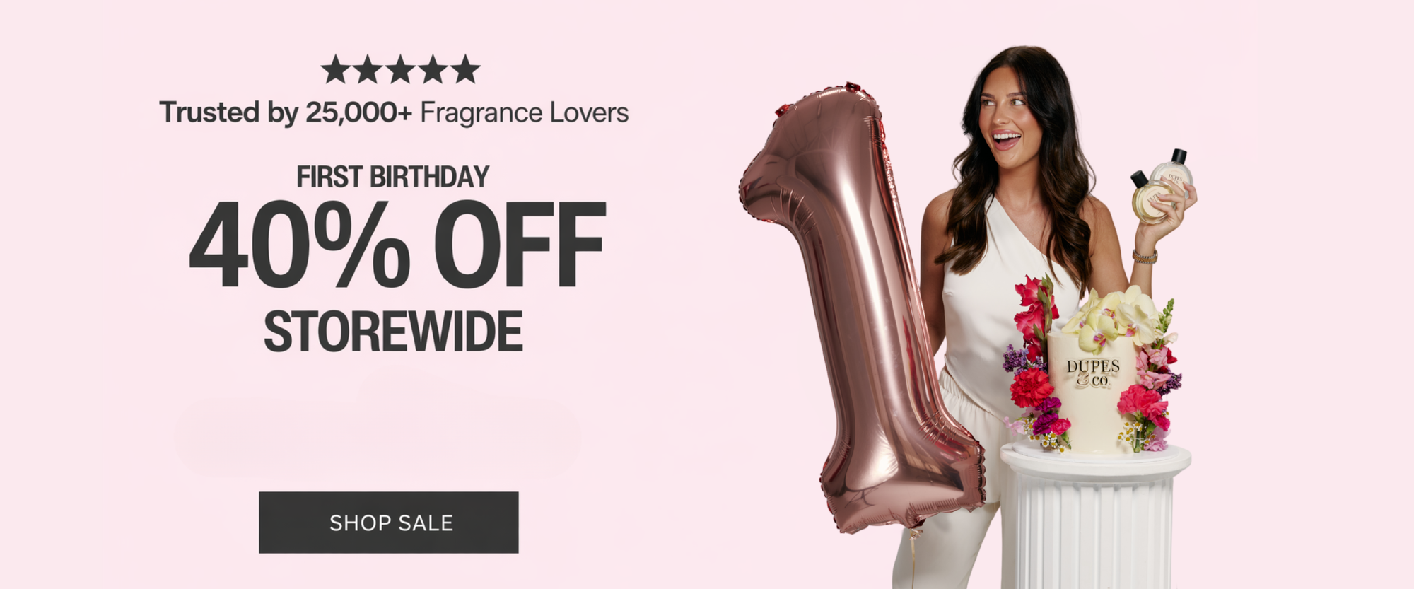 Woman holding a perfume bottle beside a rose gold number one balloon and a floral display, with text reading “Trusted by 25,000+ Fragrance Lovers – First Birthday 40% Off Storewide” and a Shop Sale button on a pink background.